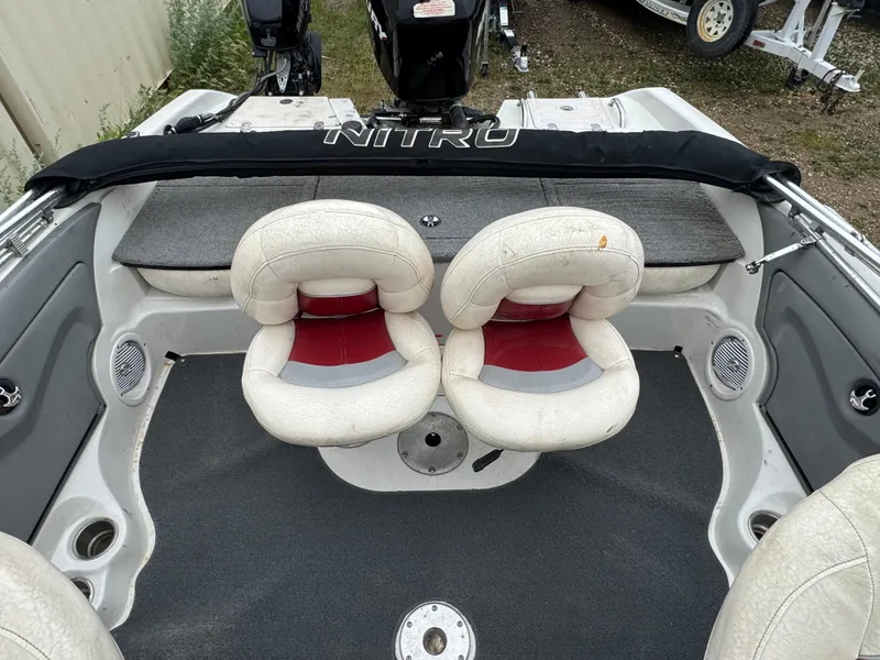 Slide: The Image of 2011 Nitro 290 Sport boat interior with red and white seating arrangement. - 7