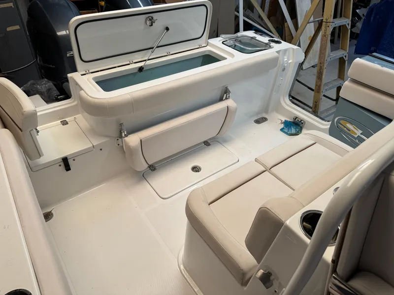 Slide: The Image of 2021 Sea Hunt Gamefish 27 boat interior with seating and storage compartments. - 2