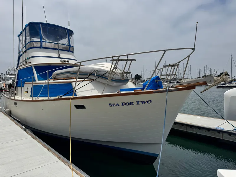 Slide: The Image of 1983 Rough Water Flybridge boat "Sea For Two" docked at marina. - 3