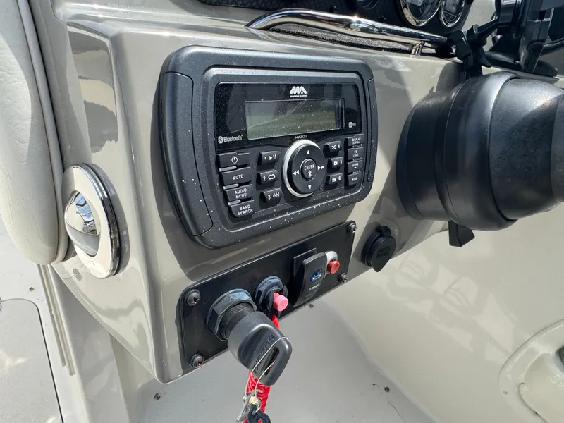 Slide: The Image of Control panel of a 2018 Stingray 234 LR boat featuring a Bluetooth stereo system. - 11