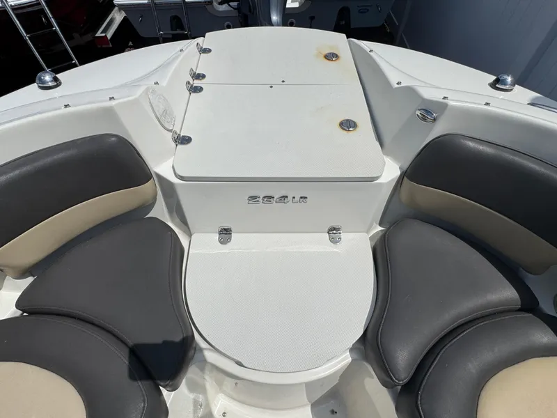 Slide: The Image of 2018 Stingray 234 LR boat interior with cushioned seating and storage compartment. - 18