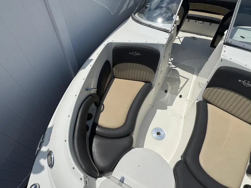 Slide: The Image of 2018 Stingray 234 LR boat interior with beige and black seating, showcasing spacious design. - 20