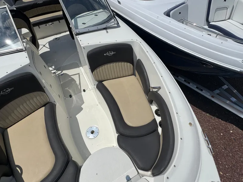 Slide: The Image of 2018 Stingray 234 LR boat interior with beige and black seating, showcasing sleek design. - 21