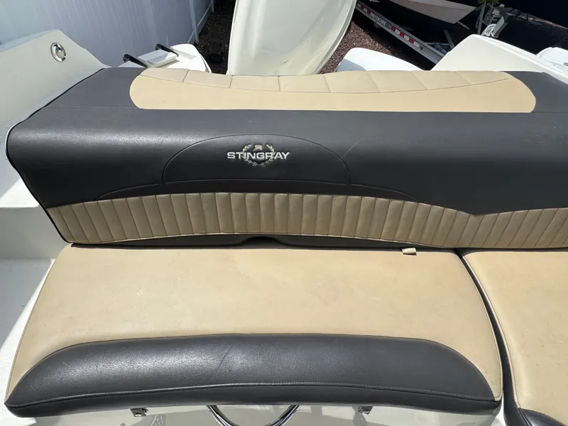 Slide: The Image of 2018 Stingray 234 LR boat seat with beige and black upholstery. - 5