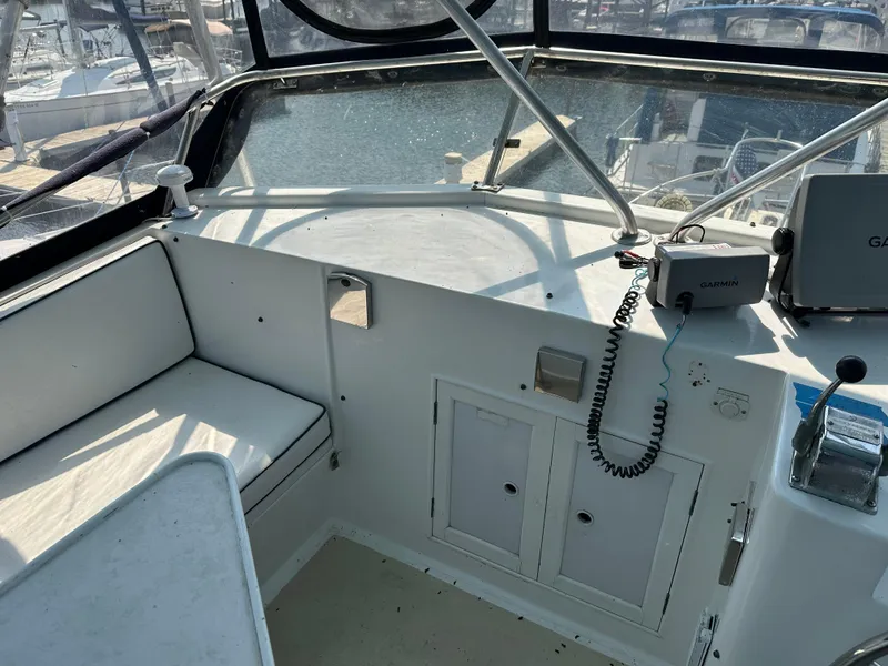 Slide: The Image of 1996 Island Gypsy 36 Aft Cabin helm with Garmin navigation system and seating area. - 13