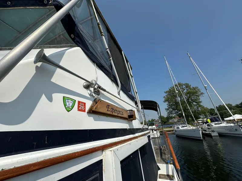 Slide: The Image of 1996 Island Gypsy 36 Aft Cabin boat docked, featuring nameplate "Esperanza" and safety stickers. - 14
