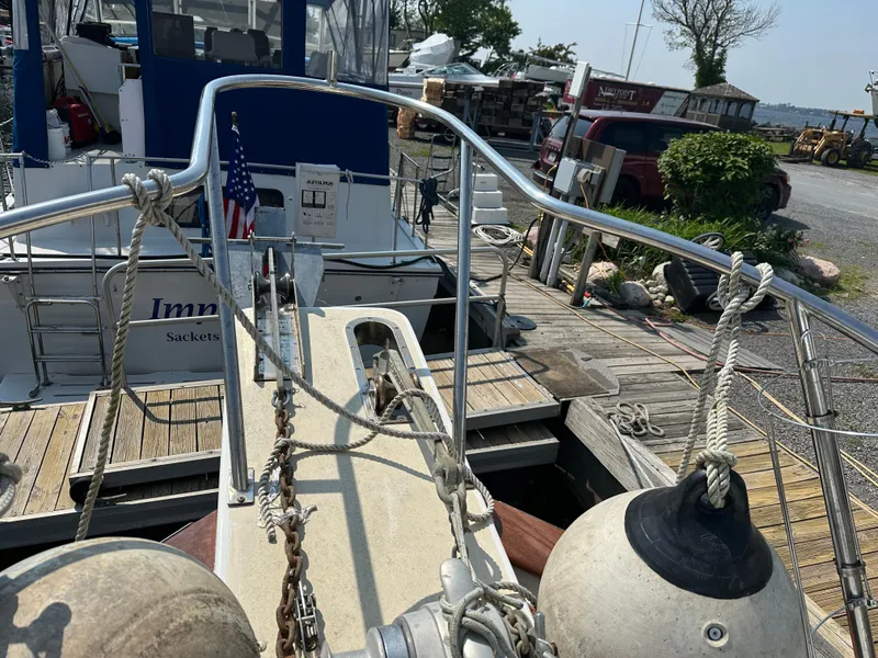 Slide: The Image of 1996 Island Gypsy 36 Aft Cabin yacht docked, featuring deck details and mooring equipment. - 18