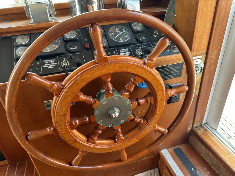 Slide: The Image of Wooden steering wheel on a 1996 Island Gypsy 36 Aft Cabin boat. - 21