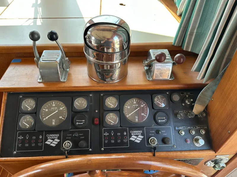 Slide: The Image of 1996 Island Gypsy 36 Aft Cabin helm with Cummins Marine controls and gauges. - 22