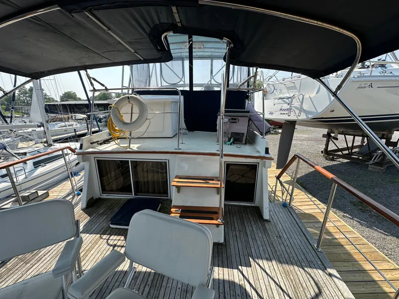 Slide: The Image of 1996 Island Gypsy 36 Aft Cabin yacht with deck chairs and life preserver. - 3