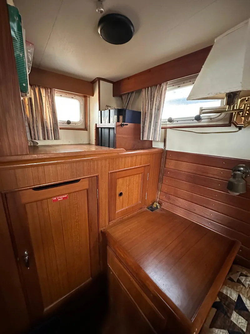 Slide: The Image of 1996 Island Gypsy 36 Aft Cabin interior with wooden cabinetry and nautical decor. - 36