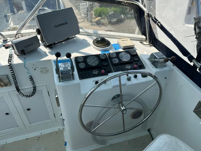 Slide: The Image of 1996 Island Gypsy 36 Aft Cabin helm with Garmin navigation equipment and steering wheel. - 4