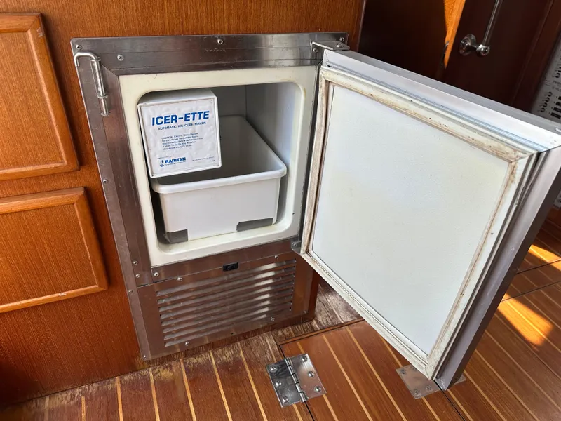Slide: The Image of Ice maker in 1996 Island Gypsy 36 Aft Cabin, wooden interior, open door. - 43