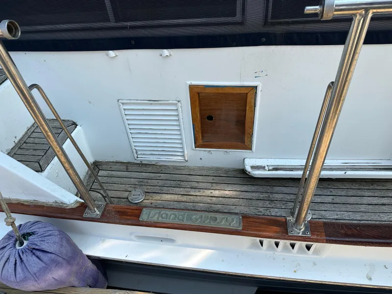 Slide: The Image of 1996 Island Gypsy 36 Aft Cabin deck with wooden flooring and metal railings. - 46