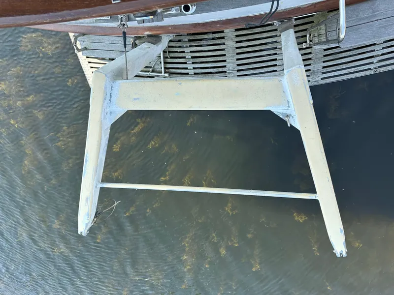 Slide: The Image of Aft view of 1996 Island Gypsy 36 Aft Cabin boat ladder over water. - 48
