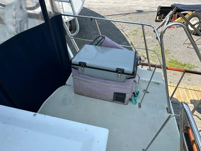 Slide: The Image of 1996 Island Gypsy 36 Aft Cabin deck with cooler and railing. - 5