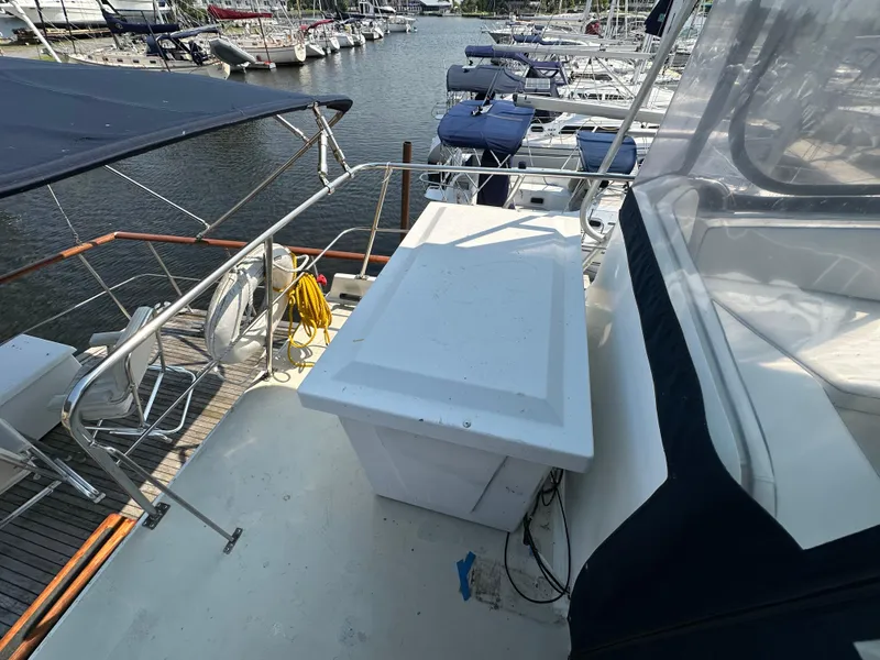 Slide: The Image of 1996 Island Gypsy 36 Aft Cabin yacht docked at marina, featuring spacious deck area. - 6