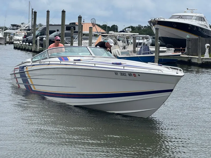 The Image of 2020 Formula 382 FASTech boat docked at marina, featuring colorful stripes. - 0