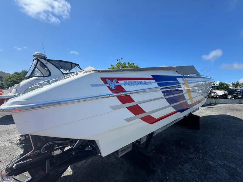 Slide: The Image of 2020 Formula 382 FASTech boat with colorful graphics, displayed outdoors under a clear blue sky. - 10