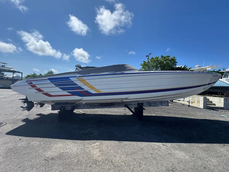 Slide: The Image of 2020 Formula 382 FASTech speedboat with colorful stripes, displayed outdoors on a sunny day. - 11