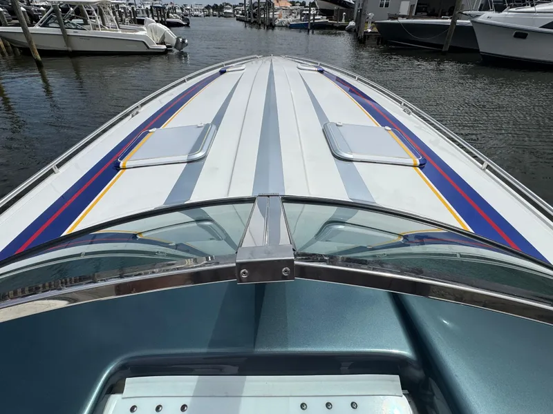Slide: The Image of 2020 Formula 382 FASTech boat with colorful stripes docked at a marina. - 13
