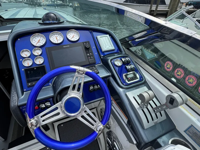 Slide: The Image of 2020 Formula 382 FASTech boat dashboard with blue steering wheel and advanced controls. - 15