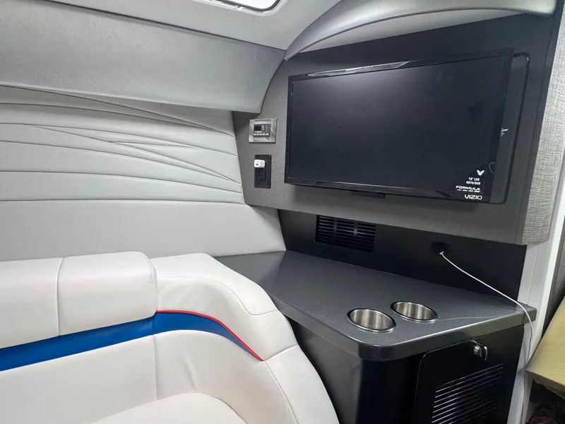 Slide: The Image of Interior of 2020 Formula 382 FASTech boat with TV, seating, and cup holders. - 23