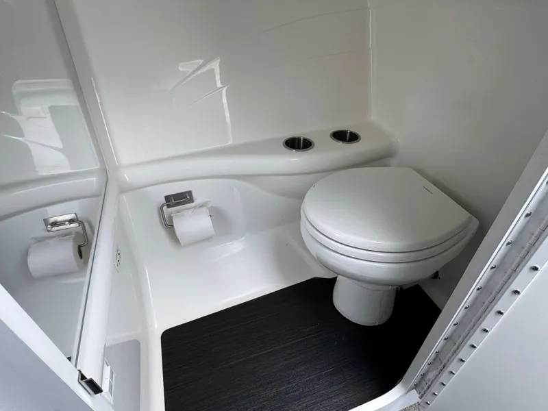 Slide: The Image of Compact bathroom in 2020 Formula 382 FASTech boat with toilet and dual cup holders. - 27