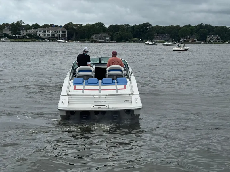 Slide: The Image of 2020 Formula 382 FASTech boat cruising on a lake with two passengers. - 8