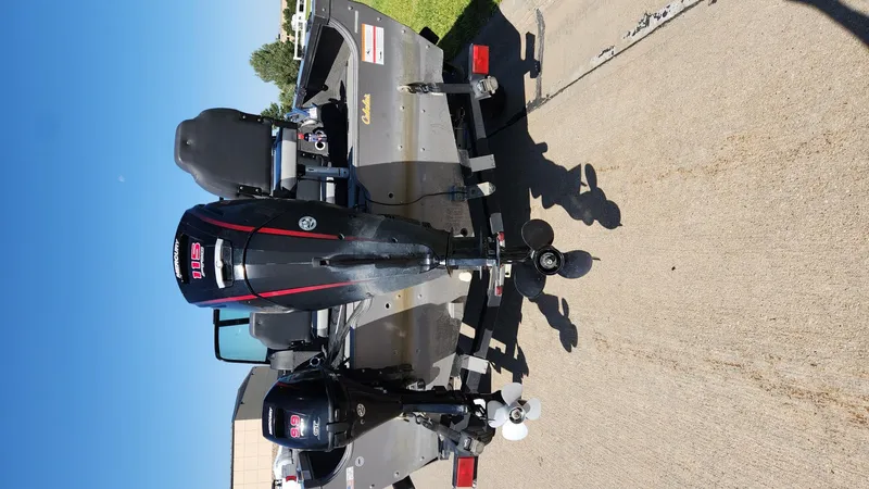 Slide: The Image of 2017 Lowe FM 1710 Pro WT boat with dual outboard motors on a trailer. - 14