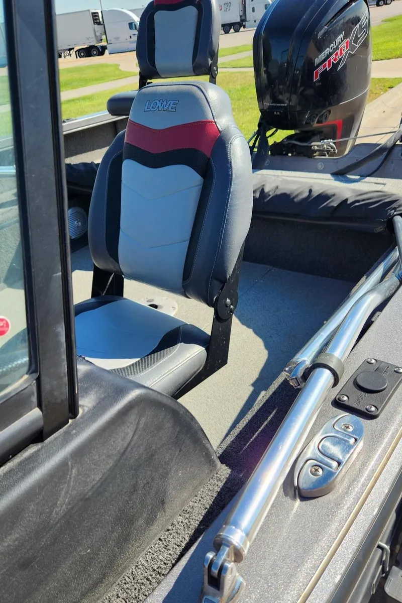Slide: The Image of 2017 Lowe FM 1710 Pro WT boat interior with seating and Mercury Pro XS engine. - 16
