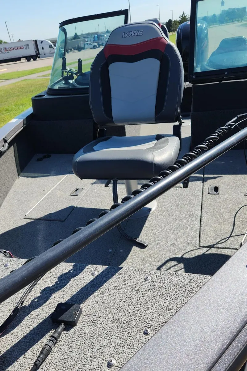 Slide: The Image of 2017 Lowe FM 1710 Pro WT boat interior with seating and equipment. - 18