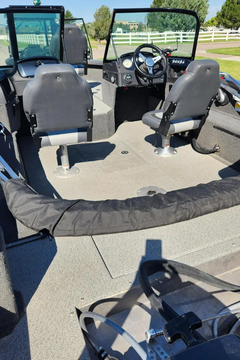 Slide: The Image of 2017 Lowe FM 1710 Pro WT boat interior with steering wheel and seating. - 19