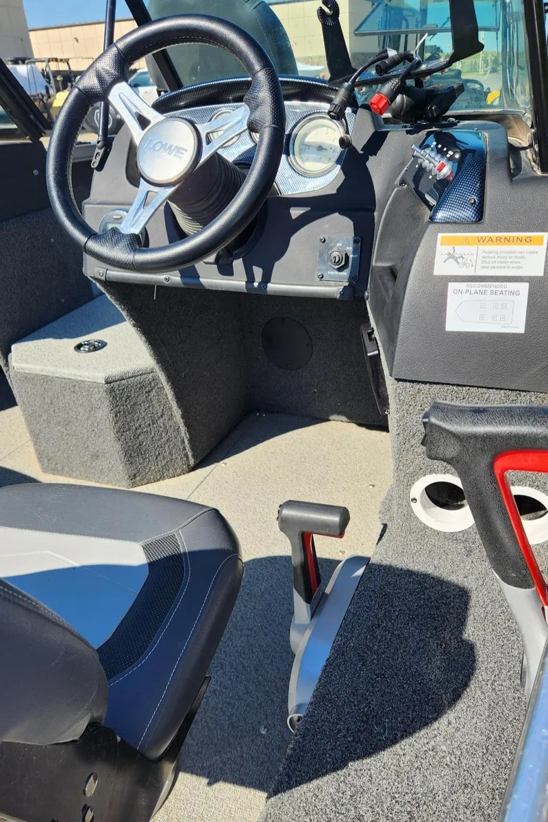 Slide: The Image of 2017 Lowe FM 1710 Pro WT boat interior with steering wheel and seating. - 21