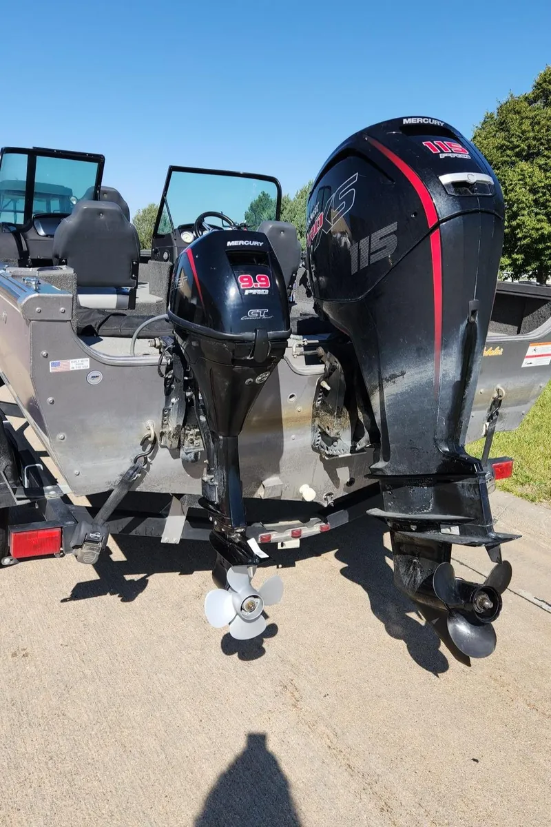 Slide: The Image of 2017 Lowe FM 1710 Pro WT boat with dual Mercury outboard motors on a trailer. - 22