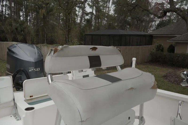 Slide: The Image of 2012 Tidewater 2200 Carolina Bay boat with worn seating and Yamaha 250 engine. - 13