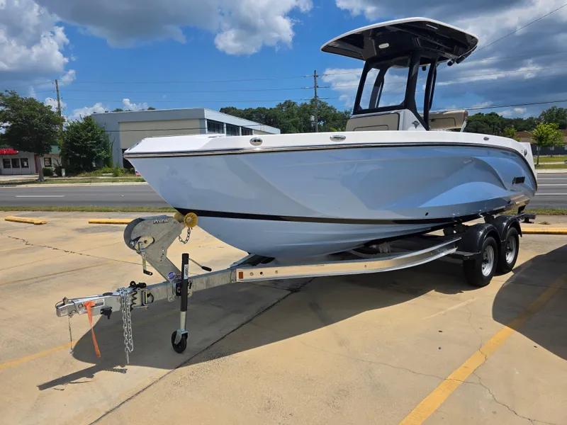 The Image of 2025 Yamaha Boats 222 FSH Sport E on trailer, parked outdoors under a cloudy sky. - 1