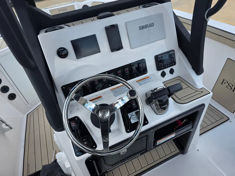 Slide: The Image of Control panel of 2025 Yamaha Boats 222 FSH Sport E with steering wheel and navigation equipment. - 10