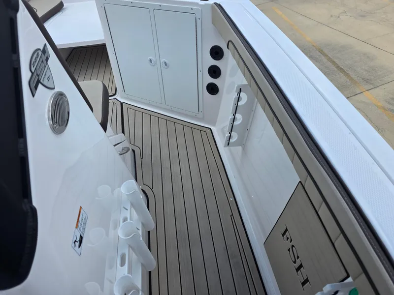 Slide: The Image of 2025 Yamaha Boats 222 FSH Sport E interior with sleek deck and storage compartments. - 8