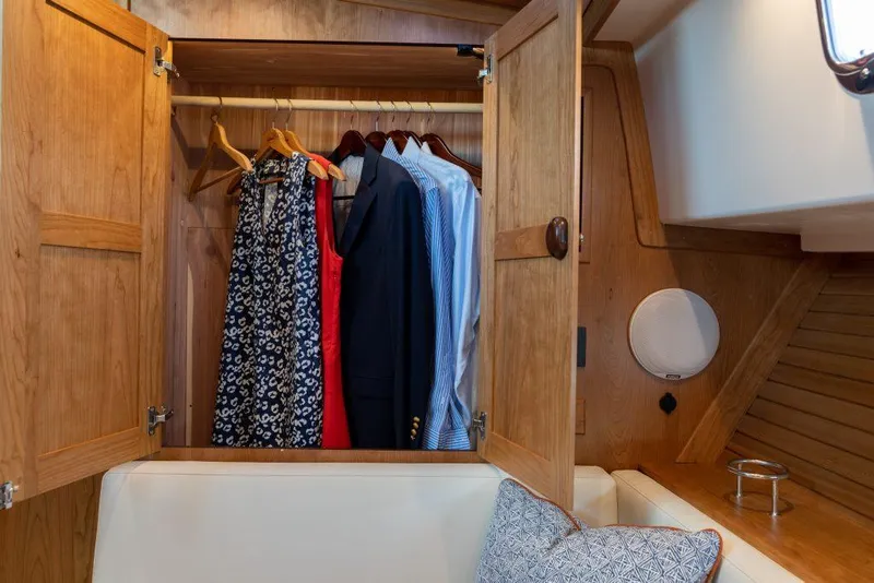 Slide: The Image of Wooden closet with clothes inside Sabre 43 Salon Express yacht, 2026 model. - 18