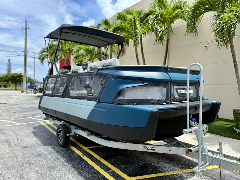 Slide: The Image of 2025 Sea-Doo Switch Cruise Limited 21 on trailer, parked near palm trees. - 5
