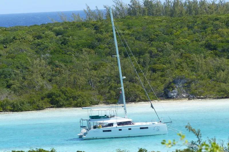 The Image of Sailing catamaran Nautitech 46 Fly 2017 anchored in turquoise waters near lush green island. - 1