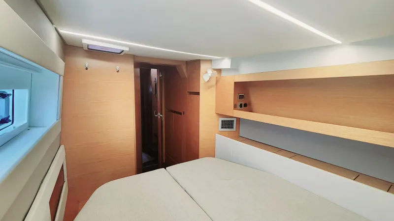 Slide: The Image of Modern cabin interior of 2017 Nautitech 46 Fly yacht, featuring sleek wood finishes and ambient lighting. - 11