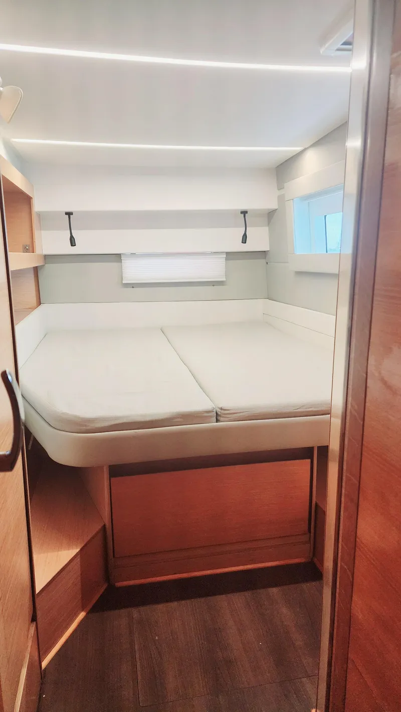 Slide: The Image of Interior cabin of 2017 Nautitech 46 Fly catamaran with bed and wooden finishes. - 13