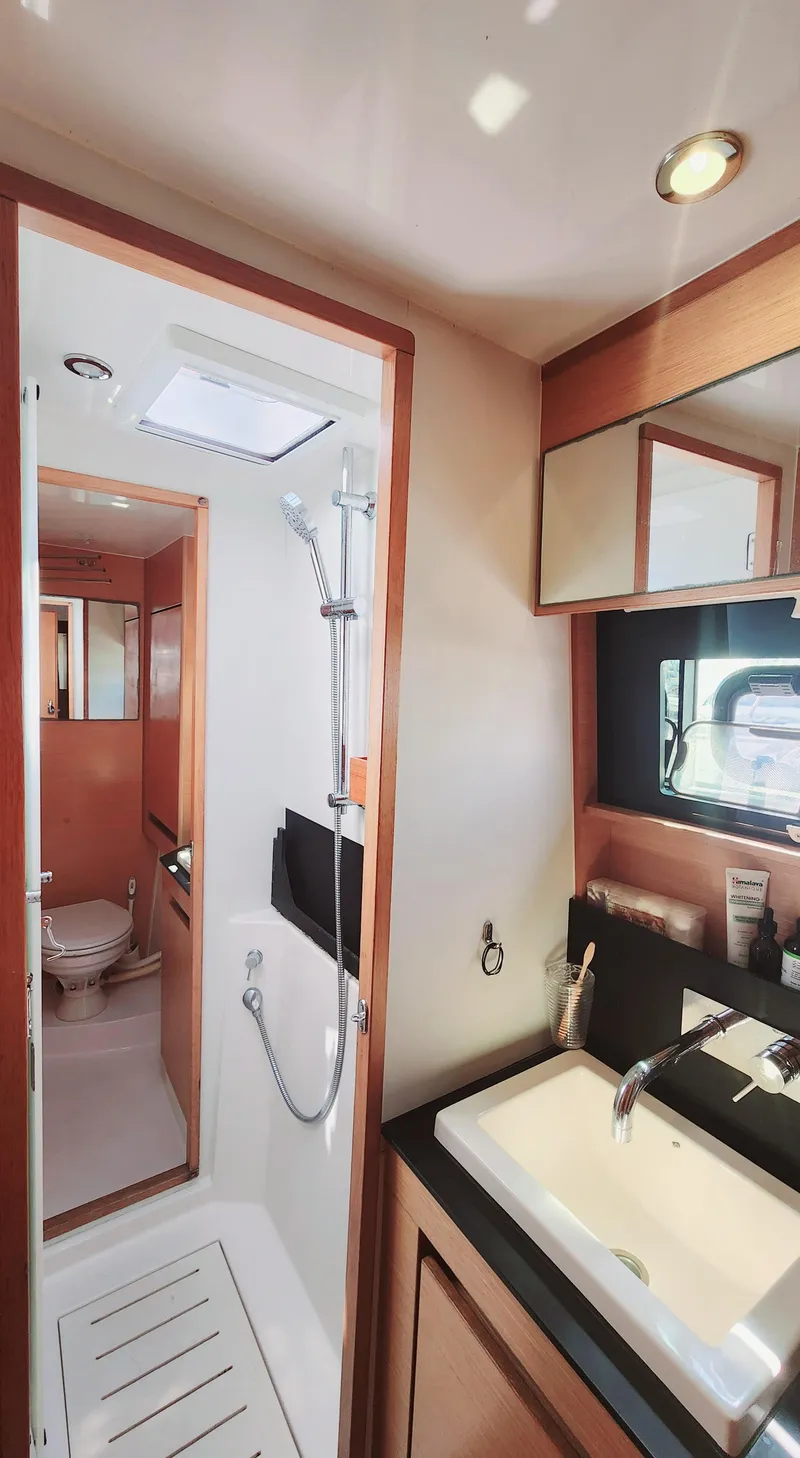 Slide: The Image of Luxurious bathroom interior of 2017 Nautitech 46 Fly catamaran with modern fixtures and wood accents. - 14