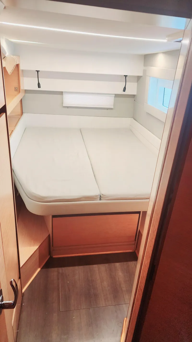 Slide: The Image of Cabin interior of 2017 Nautitech 46 Fly catamaran with bed and wooden accents. - 17