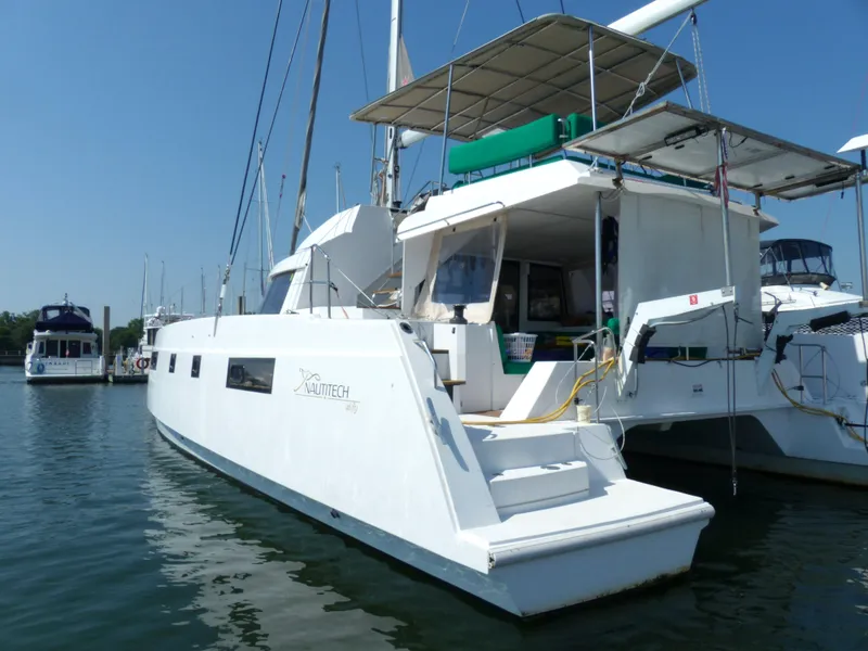 Slide: The Image of 2017 Nautitech 46 Fly catamaran docked in a marina under clear blue skies. - 34