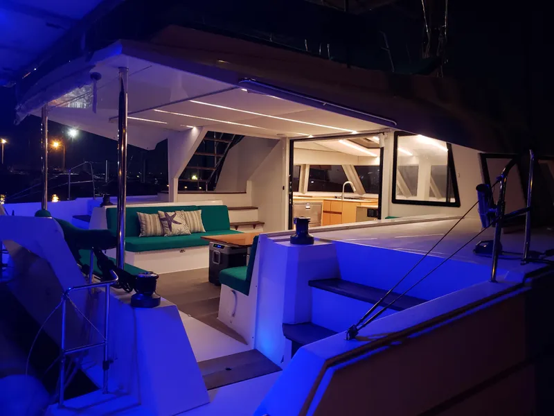 Slide: The Image of Luxurious Nautitech 46 Fly catamaran interior at night, featuring elegant seating and ambient lighting. - 35