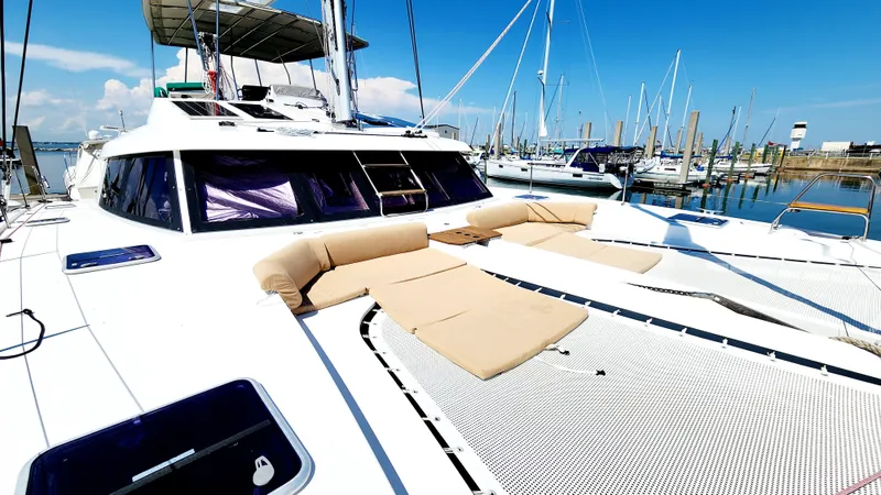 Slide: The Image of 2017 Nautitech 46 Fly catamaran with sun loungers, docked in a marina under clear blue skies. - 39
