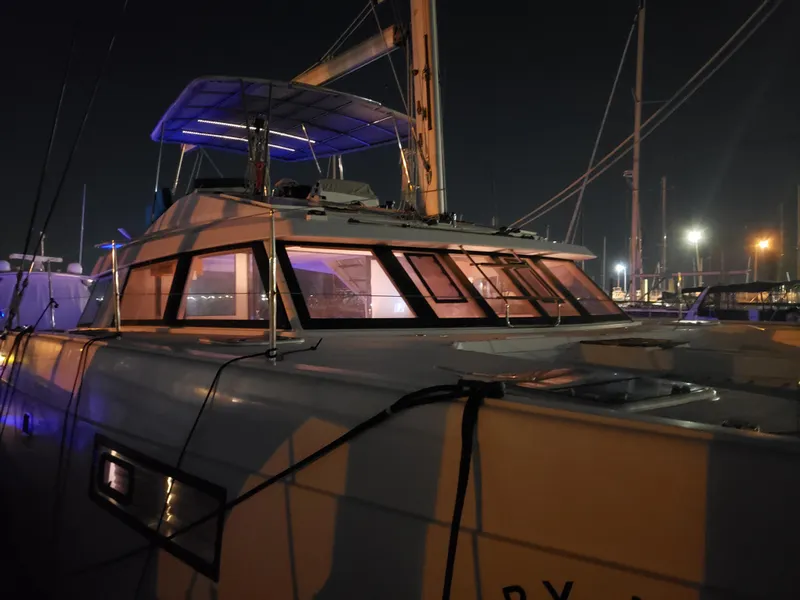 Slide: The Image of Nautitech 46 Fly 2017 catamaran docked at night with illuminated windows. - 41